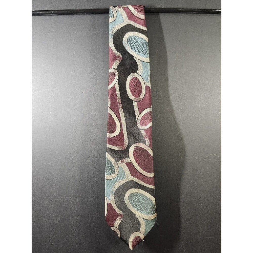DiMaro Elegante tie features a bold, abstract geometric pattern in maroon, teal,